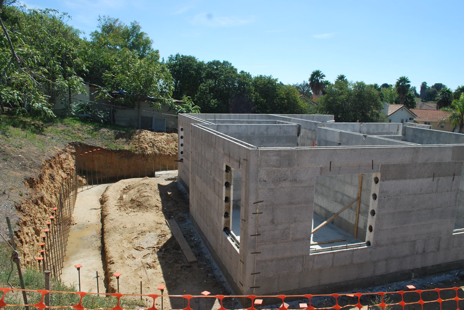 Legacy ICF forms stacked on a job site, with the open cores and the cement-bonded surface visible.