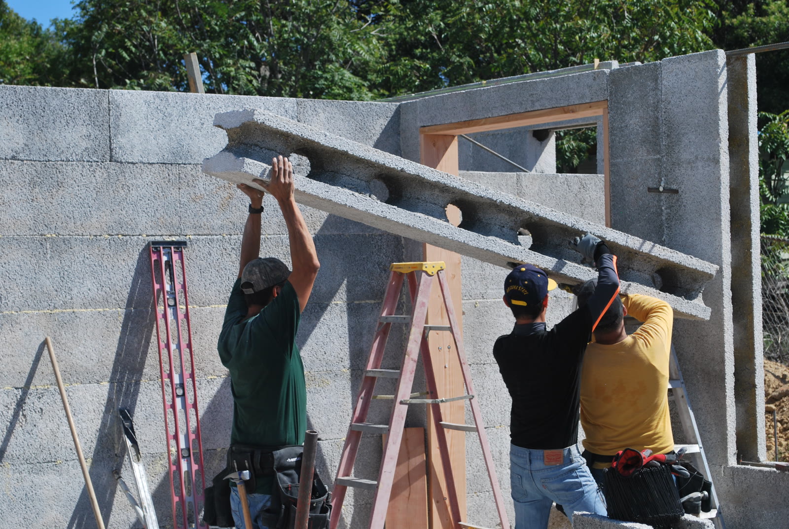 Legacy Block walls during construction, with rebar in the openings and window frames set.